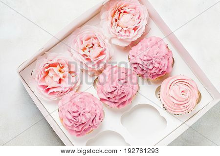Pink cupcakes with roses in box. Festive and bright. Wedding Celebration concept