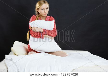 Sad Depressed Girl In Bed Gripping Pillow