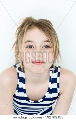 Close portrait of girl eleven years old with big green eyes on white