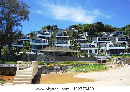 A luxurious hotel by the sea and sewerage flowing to the beach. Conceptual contrast. Ecological disaster