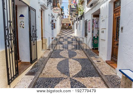 ALTEA, SPAIN - JUNE 09, 2017: Narrow shopping street in the center of Altea, Spain
