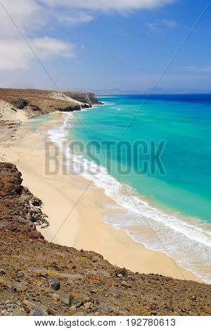 Aerial view on the beach with amazing water colors of the Atlantic Ocean in Mal Nombre on the Canary Island Fuerteventura in Spain closed to Morro Jable and Sotavento beaches.