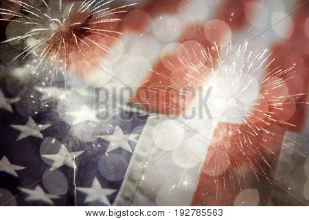 Celebratory fireworks and crowd of people on the background of the US flag. Independence day, 4th of July