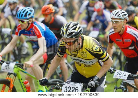 STOCKHOLM SWEDEN - JUNE 11 2017: Closeup of colorful male mountain bike cyclists at Lida Loop Mountain bike Race audience in background. June 11 2017 in Stockholm Sweden