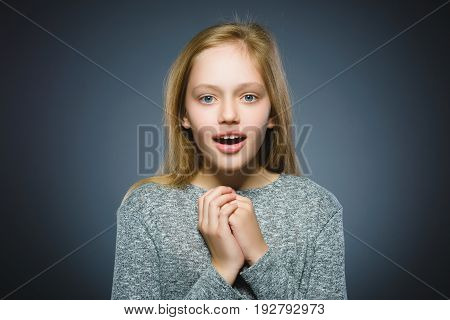 Closeup Portrait of little girl going surprise on gray background.