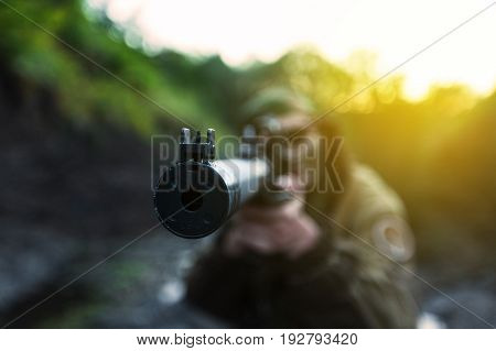 Focus woman aiming soldier muzzle background horizontal