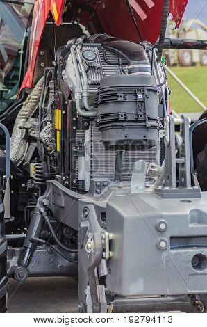 Powerful high-tech tractor engine in modern design, mounted on a frame with an open hood