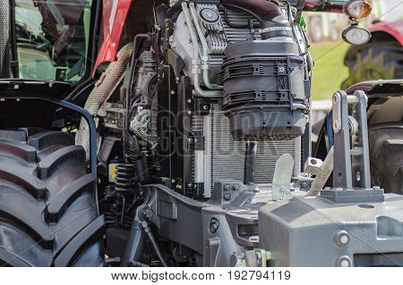 Powerful high-tech tractor engine in modern design, mounted on a frame with an open hood