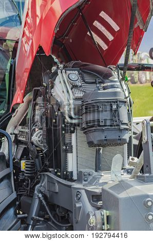 Powerful high-tech tractor engine in modern design, mounted on a frame with an open hood