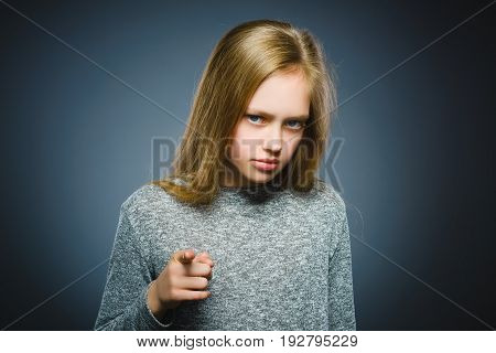 Closeup Thoughtful or contemptuous girl show at camera isolated on Gray.