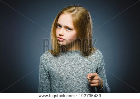 Closeup Thoughtful or contemptuous girl show at camera isolated on Gray.