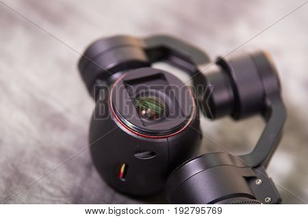 QUITO, ECUADOR- DECEMBER 22, 2017: Close up of Osmo Mobile gimbal, new generation of electronic stabilizer over a gray background.