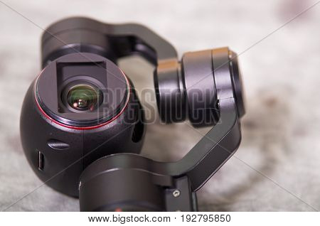QUITO, ECUADOR- DECEMBER 22, 2017: Close up of Osmo Mobile gimbal, new generation of electronic stabilizer over a gray background.