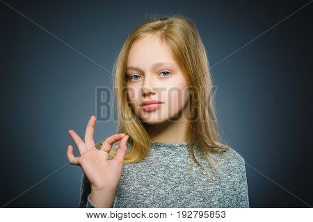 Closeup Portrait of handsome teen show Ok isolate on grey background.