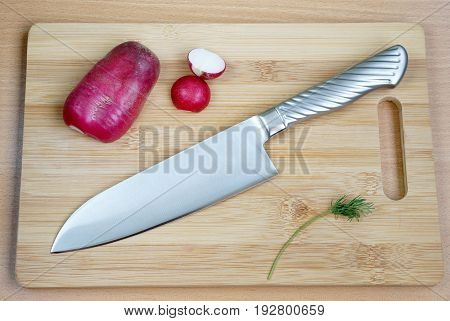 Knife cook universal with a blade like Santoku on a chopping board
