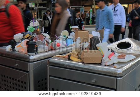 MELBOURNE AUSTRALIA - JUNE 14, 2017: Overflown public rubbish bin in downtown Melbourne