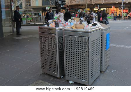 MELBOURNE AUSTRALIA - JUNE 14, 2017: Overflown public rubbish bin in downtown Melbourne