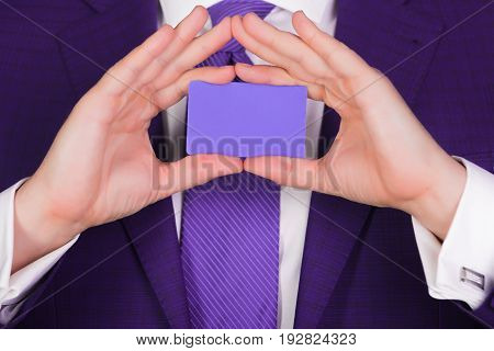 Male Hands Holding Blank Violet Business Or Bank Card
