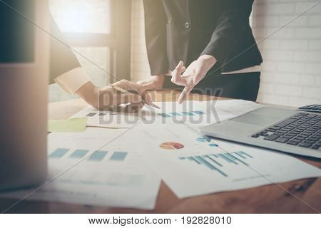 Close-up Of Female And Male Hands Pointing At Turnover Graph While Discussing It