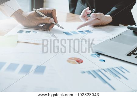 Close-up Of Female And Male Hands Pointing At Turnover Graph While Discussing It