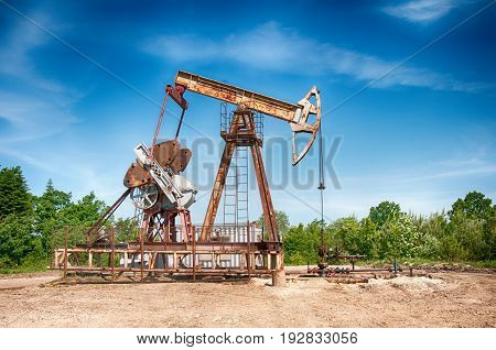 an oil pump is on a background mountains
