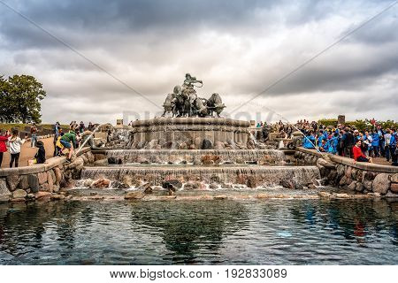 Copenhagen Denmark - August 10 2016. The Gefion Fountain is a large fountain in Copenhagen view with a crowd of tourist a cloudy day of summer. It is located in Langelinie Park is the largest monument in Copenhagen.