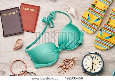 Bright accessories for voyage abroad. Beach items on wooden floor.