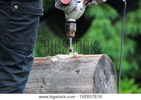 Metal spiral drill for making holes in logs when assembling a wooden frame and building a house.