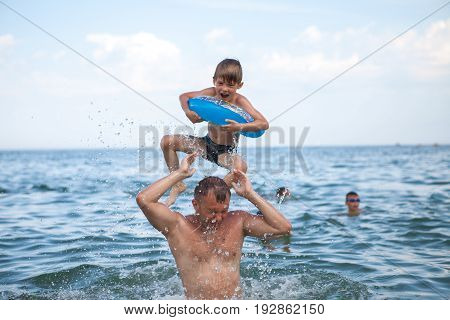 A Happy Family, Father And Son Bathe In The Water. Happy Family On Vacation, Vacation. Have Fun Play