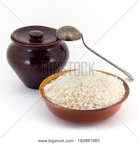Still life of Rice cereal in ceramic pial, ceramic pot, old spoon isolated on white background