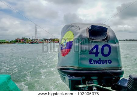 MUISNE, ECUADOR- MAY 06, 2017: Boat engine, wave trace visible on water from driving, great perspective and beautiful colours in Muisne Ecuador.