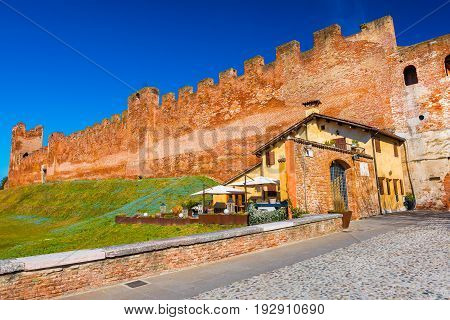 Medieval walled town. Castelfranco Veneto, Italy. Brick wall with towers and clear blue sky on the background.