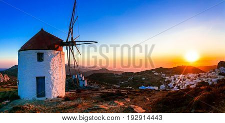 Idyllic landscape with windmills over sunset. Amorgos isalnd, Greece