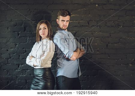 business team male and female formed of young businessmen standing over a dark background.