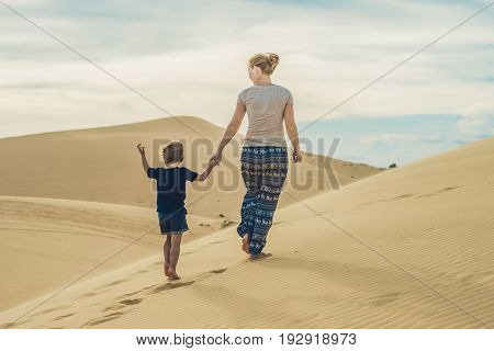 Mom And Son In The Desert. Traveling With Children Concept