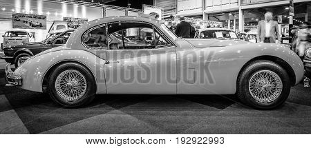MAASTRICHT NETHERLANDS - JANUARY 14 2016: A sports car Jaguar XK140 Coupe 1956. Black and white. International Exhibition InterClassics & Topmobiel 2016