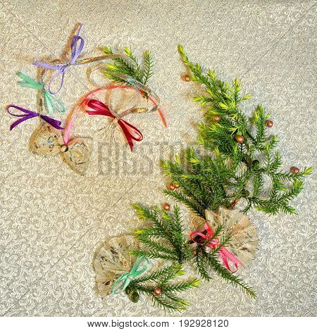 Christmas tree wreath silhouette made from fir branches on a gold cloth background. Handmade bows and fans as a xmas decorations. Spanish culture new year concept.
