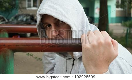 A strong, healthy man, doing pullups on the bars Park Sunrise workout,
