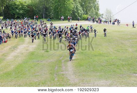 STOCKHOLM SWEDEN - JUNE 11 2017: Lots of mountain bike cyclist struggling in a steep uphill at Lida Loop Mountain bike Race. June 11 2017 in Stockholm Sweden