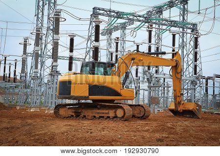 Excavator in industrial construction of electrical substation. Construction machinery works on industrial construction site