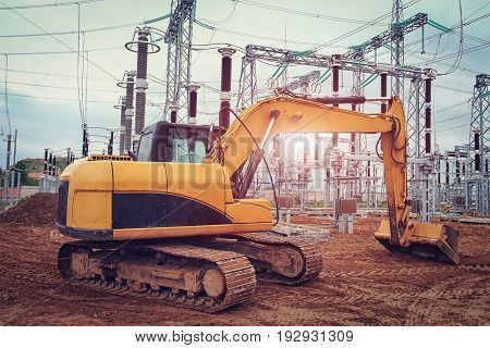Mechanisms of excavator at  construction site of power station of electricity. Construction industry of industrial equipment