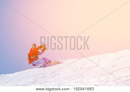 Snowboarder with a kite on fresh snow in the winter in the tundra of Russia against a clear blue sky. Teriberka, Kola Peninsula, Russia. Concept of winter sports snowkite.