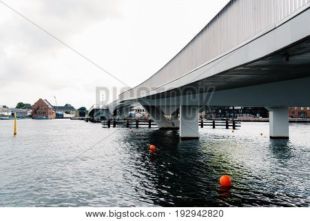 Copenhagen Denmark - August 12 2016: Inderhavnsbroen the Inner Harbour Bridge is a bridge across the Copenhagen inner harbour combined pedestrian and bicyclist bridge a cloudy day of summer.