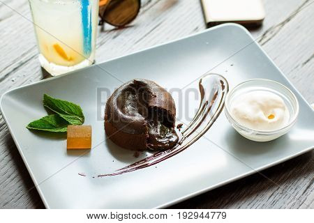 Chocolate fondant on plate on a wooden table