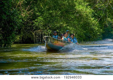 CUYABENO, ECUADOR - NOVEMBER 16, 2016: Unidentified people travelling by boat into the depth of Amazon Jungle in Cuyabeno National Park, Ecuador.