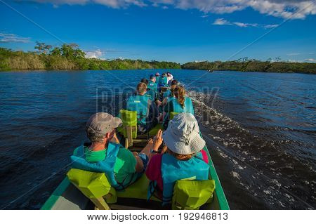 CUYABENO, ECUADOR - NOVEMBER 16, 2016: Unidentified people travelling by boat into the depth of Amazon Jungle in Cuyabeno National Park, Ecuador.