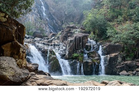 Lodh waterfall with sun rays in Jharkhand,India. Lens flare and light leak.