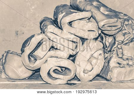 Wet white clay closeup. Abstract pieces of wet clay on the table