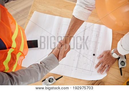 Firm handshake of contractor and head engineer