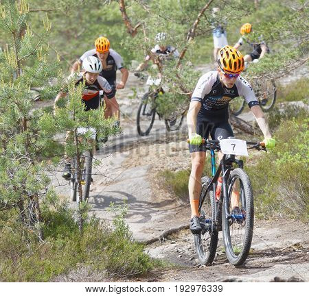 STOCKHOLM SWEDEN - JUNE 11 2017: Group of mountain bike cyclists in the forest at Lida Loop Mountain bike Race. June 11 2017 in Stockholm Sweden